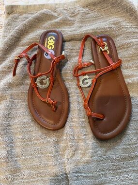 G by Guess Red-Orange Strappy T‑Bar Sandals with Gold G Accent